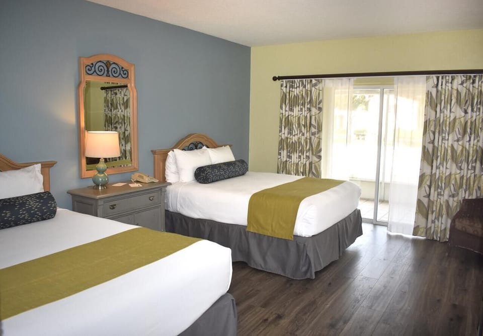 Recharge together in a comfortable double-bed room with natural light.
