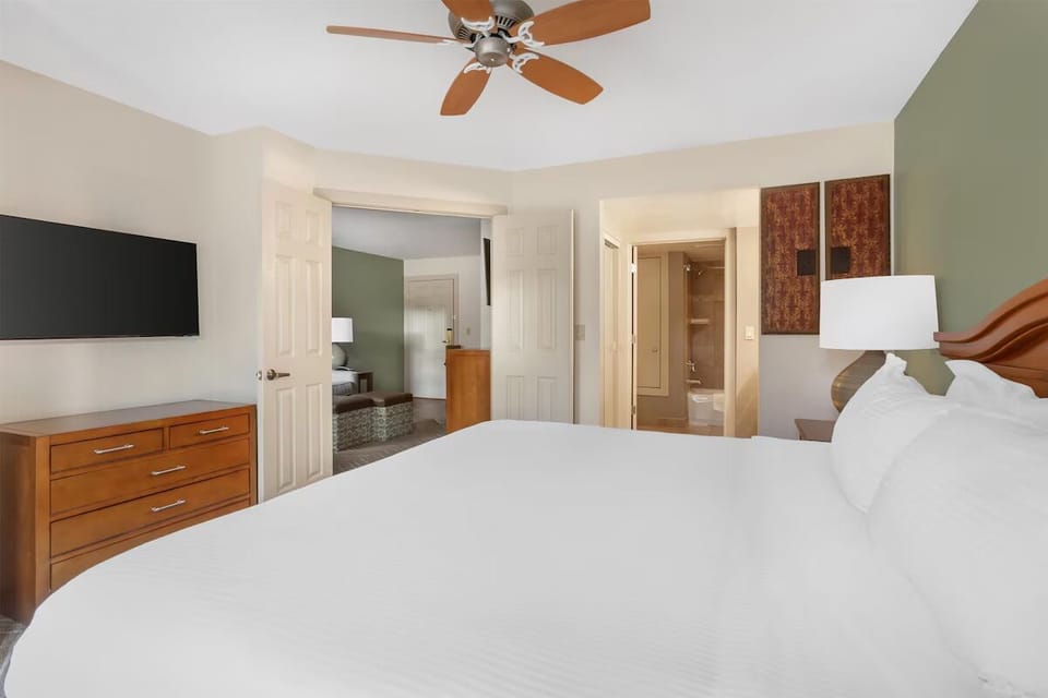 Stretch out in a spacious bedroom with bedside lighting.