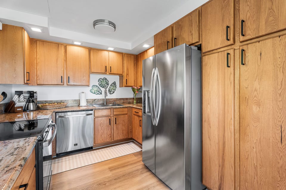 Full kitchen includes fridge, oven with electric cooktop, dishwasher, toaster oven, microwave, coffee maker