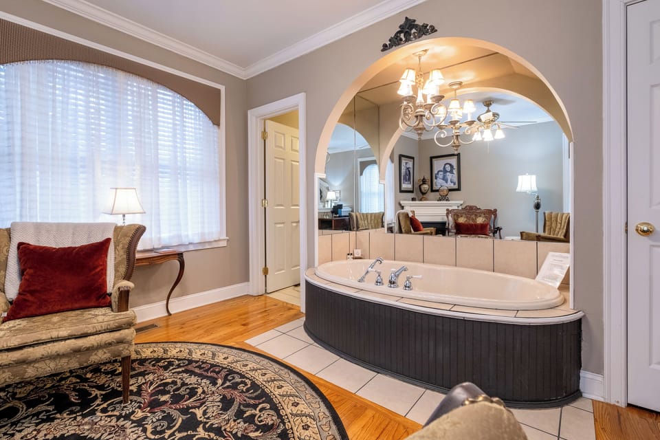 Oversized jetted soaking tub set beneath a graceful arch, creating a true spa experience.