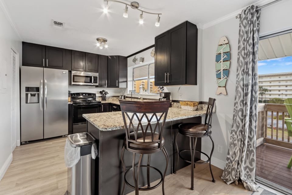 Spacious kitchen with bar seating, ideal for casual breakfasts and evening drinks.
