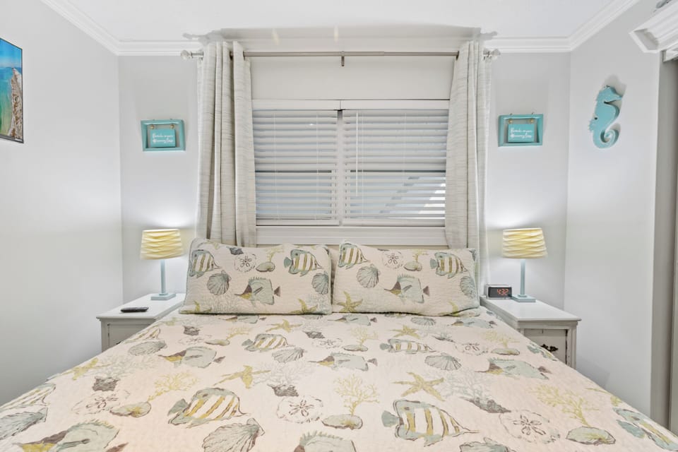 Coastal-inspired bedroom with cozy bedding and soft lighting.

