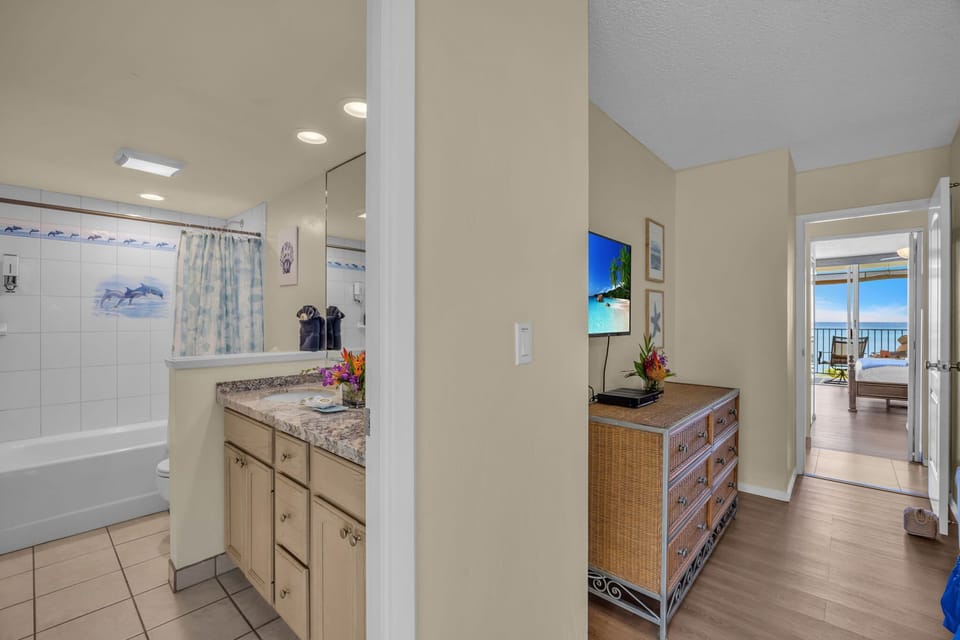 2nd Bathroom with convenience of a shower-tub, eco-friendly refillable tropical shampoo and conditioner, towels, toilet paper, tissues etc provided