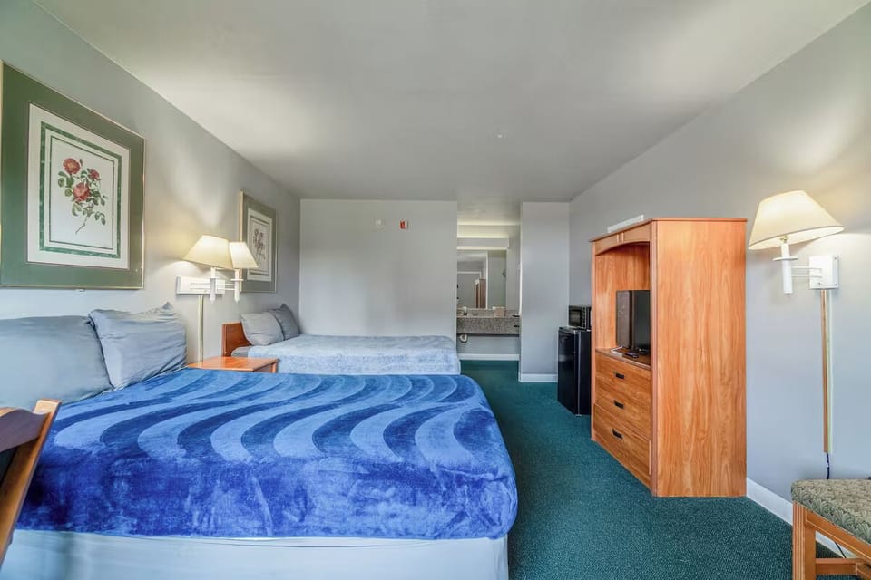 Recharge with convenient in-room storage and bedside lighting.