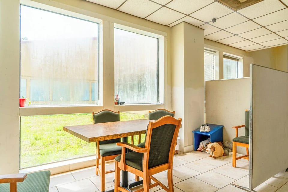 Enjoy morning coffee at the table beside bright picture windows.