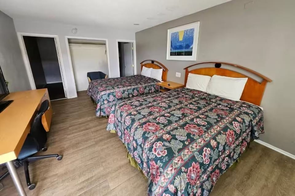 Recharge in a classic two‑bed room with work desk.