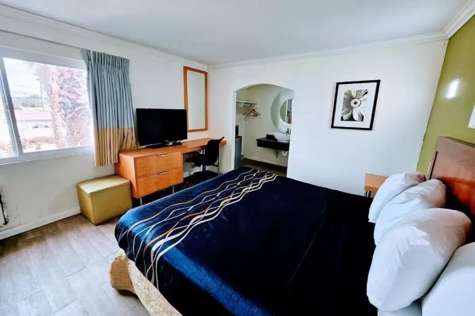 Unwind in a bright king room with TV and workspace.