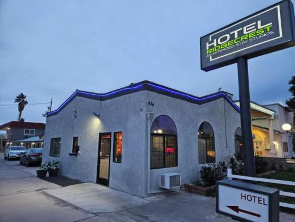 Arrive at a welcoming, well-lit hotel entrance at dusk.