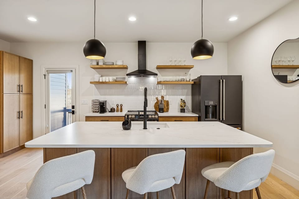 Kitchen: Cook, snack, and gather in this sleek modern kitchen—fully equipped and ready for big-group meals and unforgettable moments.