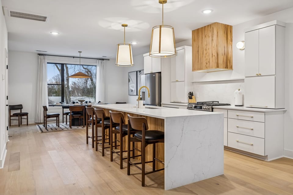 Kitchen: Sleek lines, warm tones, and high-end touches — the perfect kitchen for cooking, entertaining, and enjoying life together.