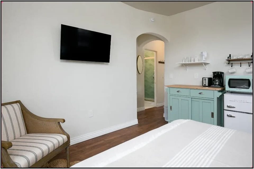 Your cozy suite combines comfort and convenience with a charming kitchenette, flat-screen TV, and elegant seating area for relaxing evenings.
