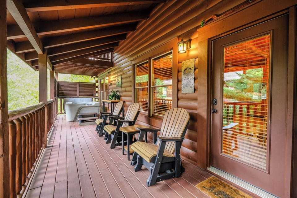 Step outside to the wrap-around deck, featuring rocking chairs, a hot tub and a charcoal grill, perfect for enjoying the fresh mountain air and scenic views.