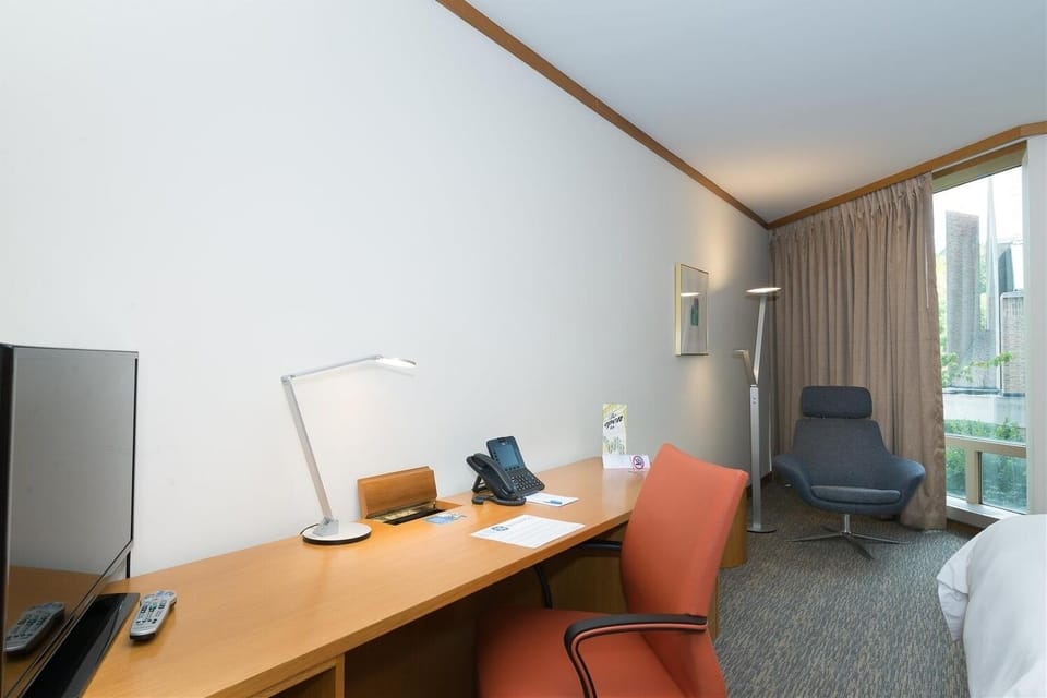 Plan your day at the roomy desk beside a cozy chair.