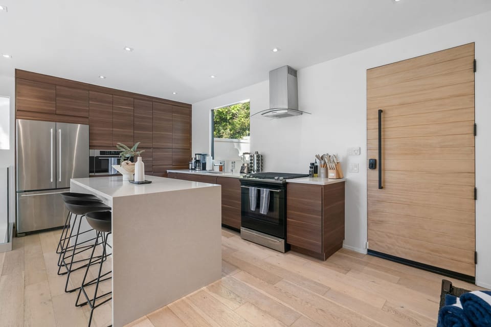 Kitchen — Island with Bar Stools, Walnut Cabinetry & Stainless Appliances