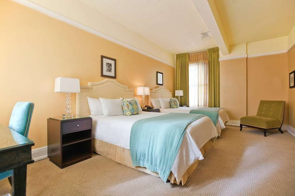 Experience tranquility in our elegantly designed room with two queen beds, perfect for a comfortable and restful night.