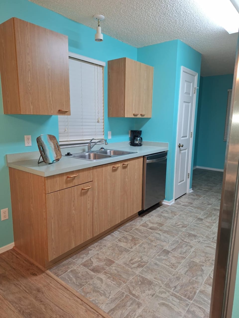 Kitchen includes a new dishwasher and refrigerator with an ice maker
