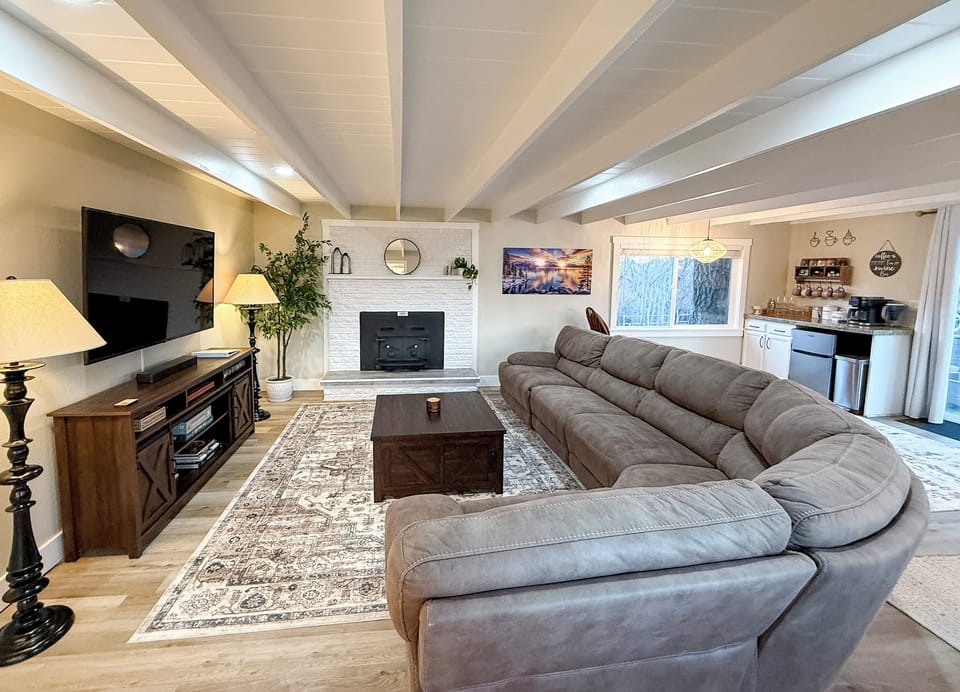 Cozy TV area with Bose sound bar and console stocked with games & books