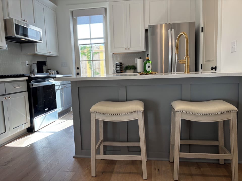 The well-appointed kitchen features a large gas range and modern appliances.