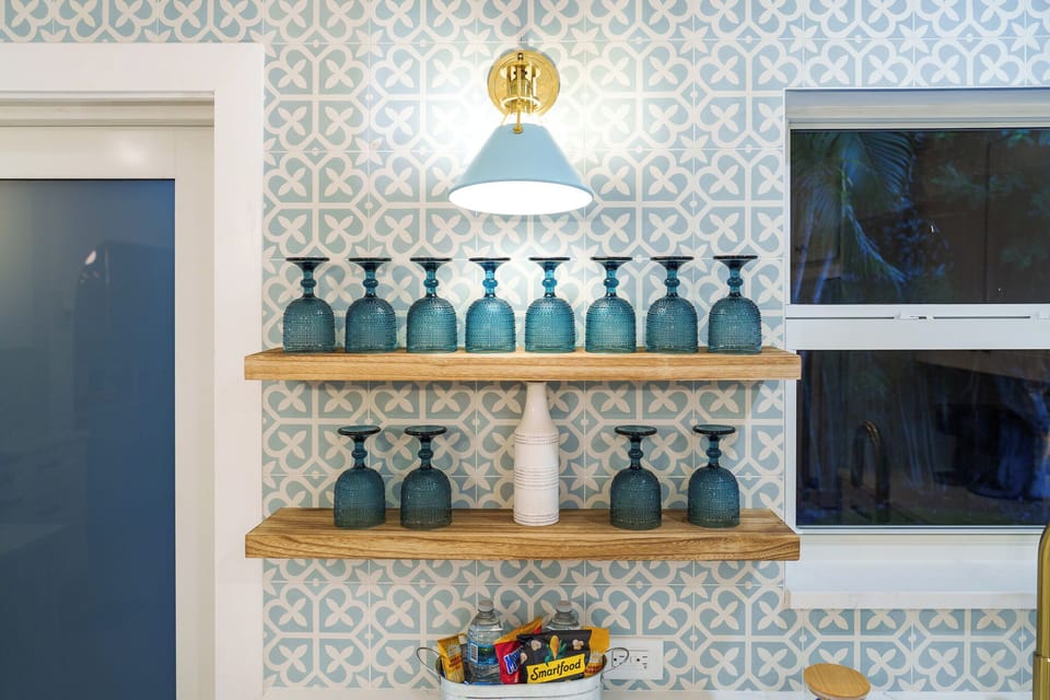 It’s all in the details. Elegant shelving and curated glassware add a touch of luxury to your stay.