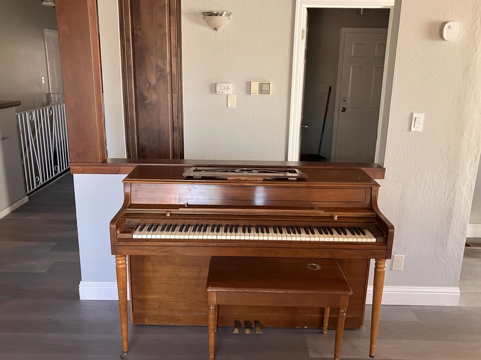 Piano in upstairs livingroom dining area.  