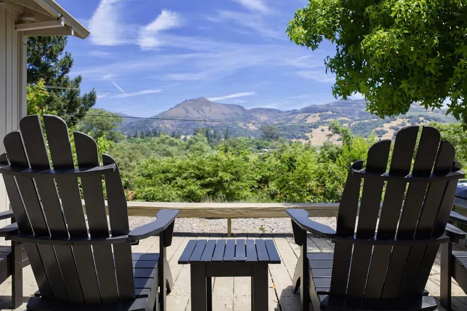 Soak in sweeping valley views from the cozy deck, with Adirondack chairs—perfect for morning coffee, sunset wine, and pure relaxation.