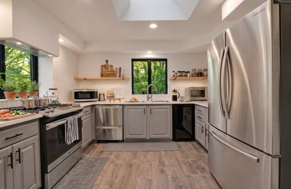 Kitchen: Equipped with basic cookware, microwave, oven toaster, and hot water kettle.