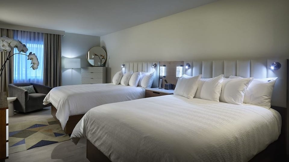 Settle in together with two plush beds and soft lighting.