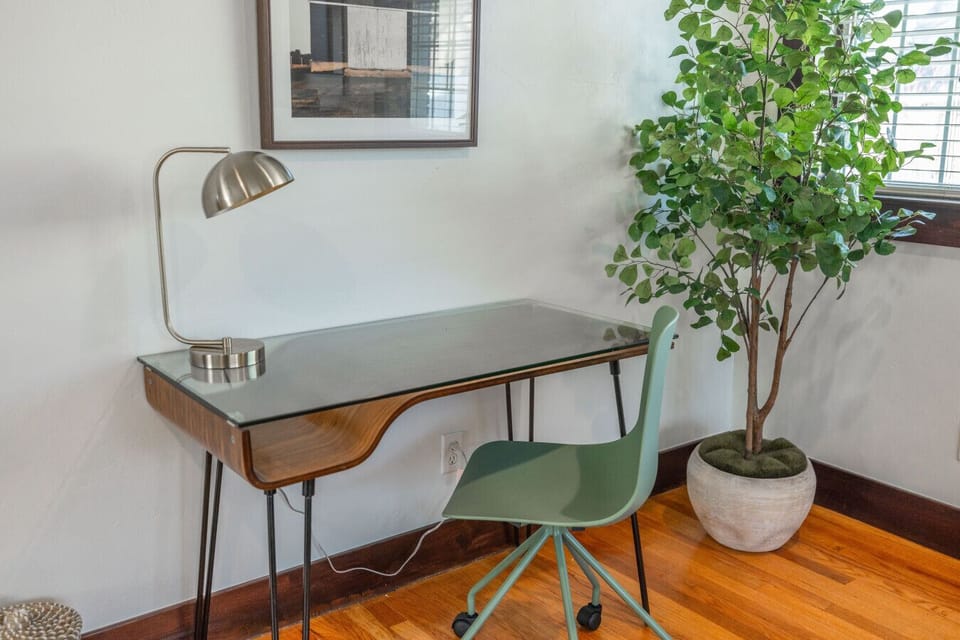Dedicated workspace with desk and comfortable seating.