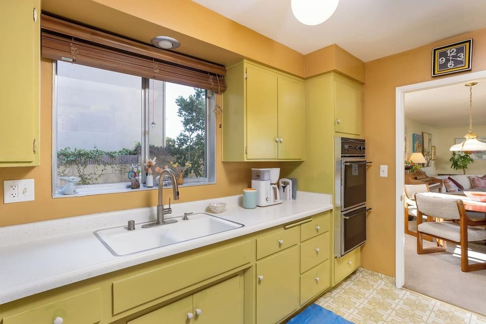 A charming, fully stocked kitchen blending vintage character with modern essentials for everyday meals or shared family dinners.