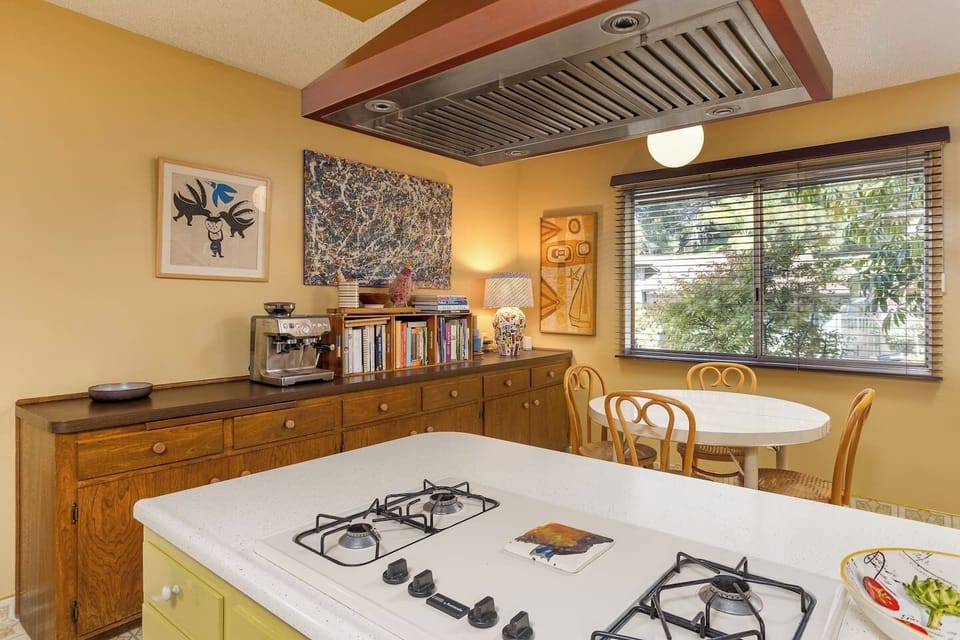 A charming, fully stocked kitchen blending vintage character with modern essentials for everyday meals or shared family dinners.