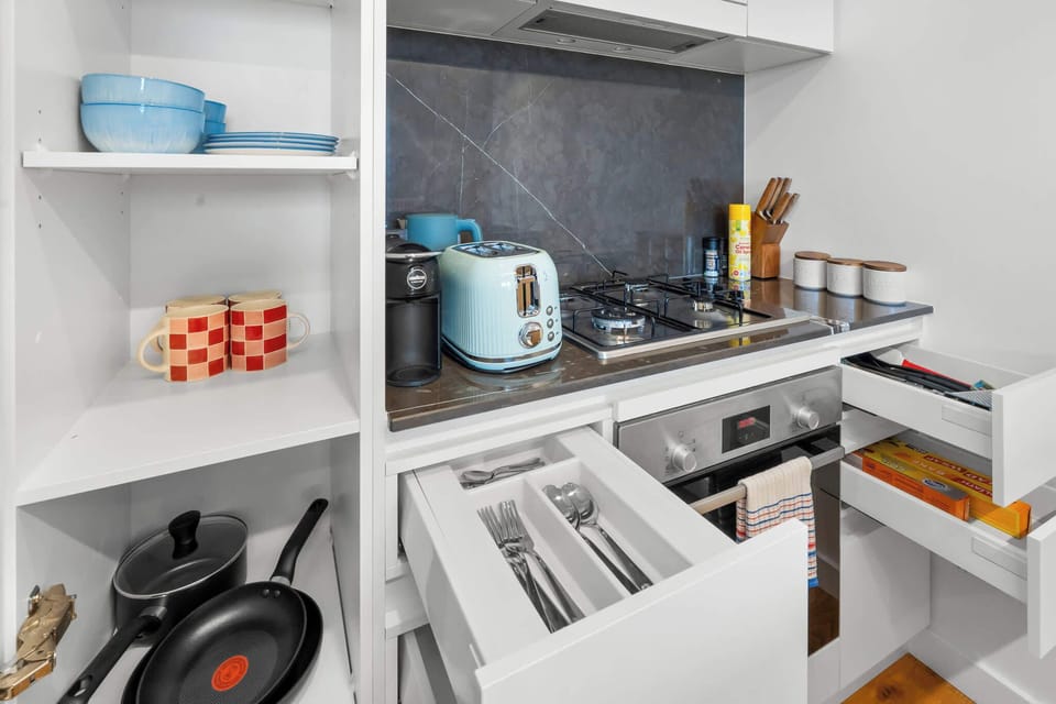 Fully equipped kitchen with microwave, fridge, cookware and utensils, everything you need for easy meals.