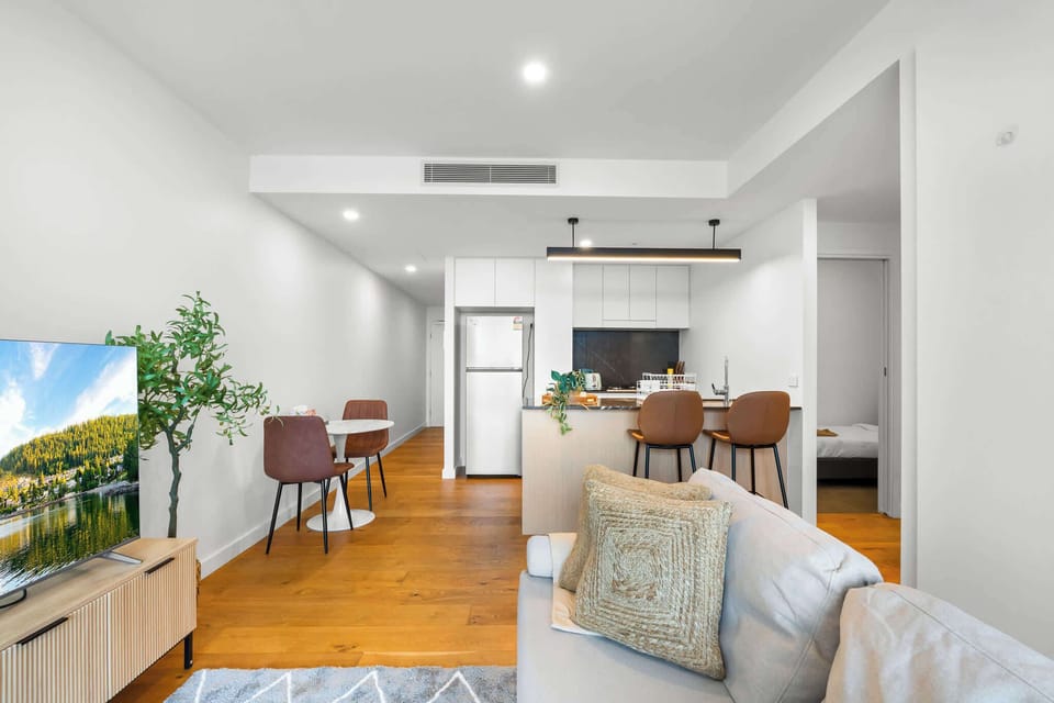 Relax in the open living space with a Smart TV ready for Netflix, flowing easily into the dining and kitchen areas.