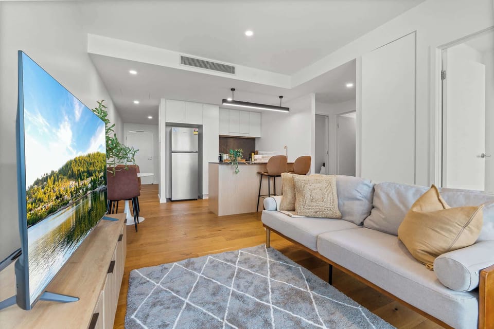 Comfortable sofa and a Netflix-ready Smart TV, with the kitchen and dining area just steps away.
