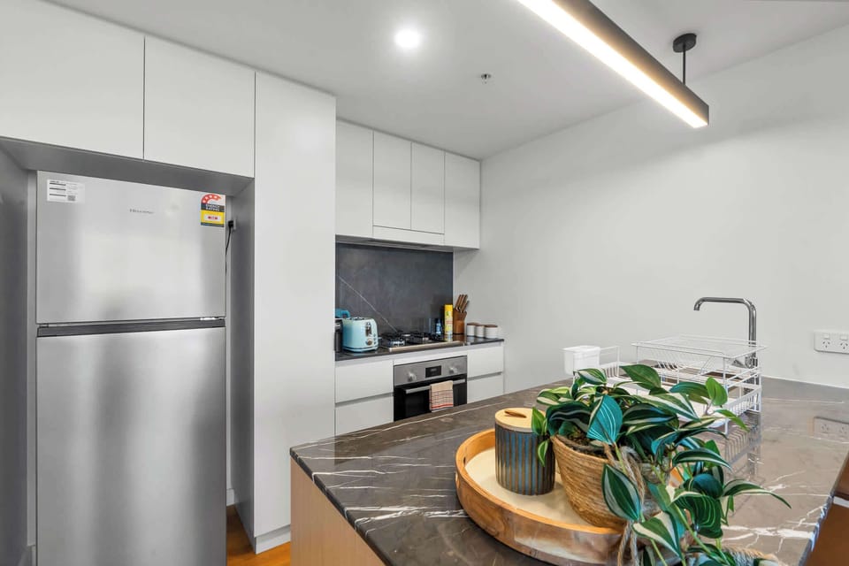Modern kitchen with gas cooktop, oven, kettle and toaster. Coffee, tea and sugar are provided for your stay.