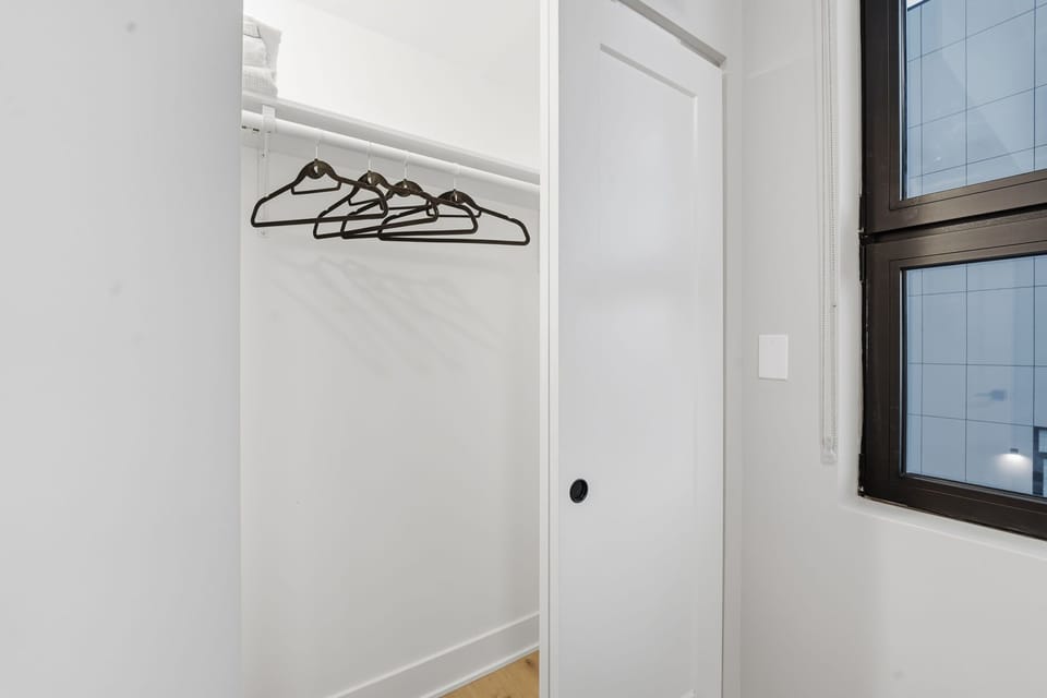 Clean closet space ideal for coats, bags & folded clothes
