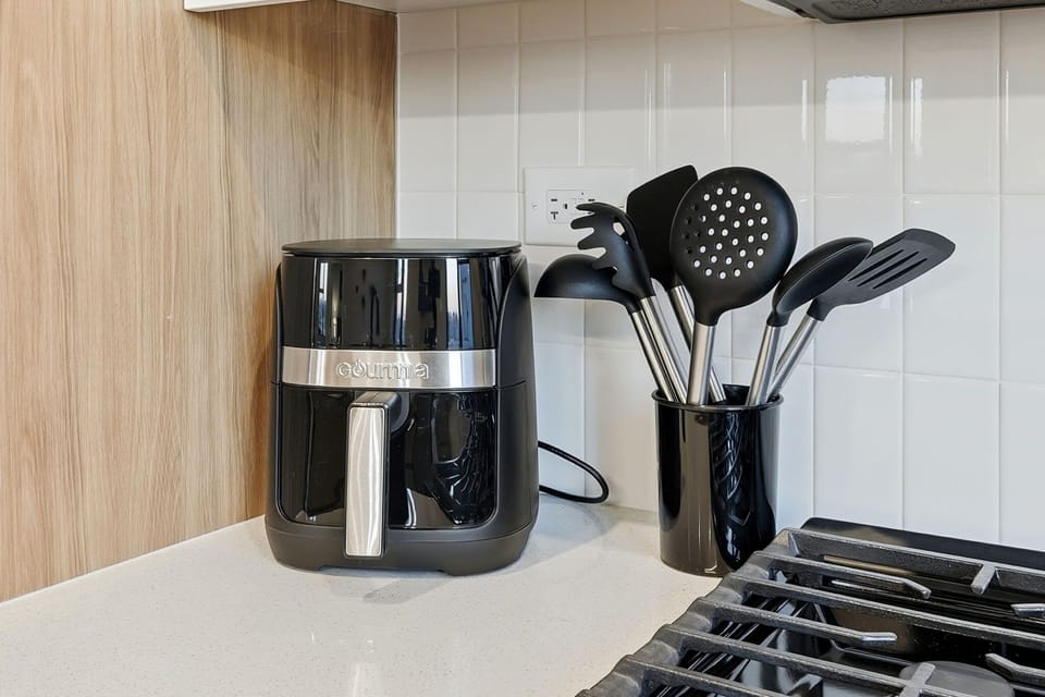 Cooking utensils and air fryer for easy food preparation.