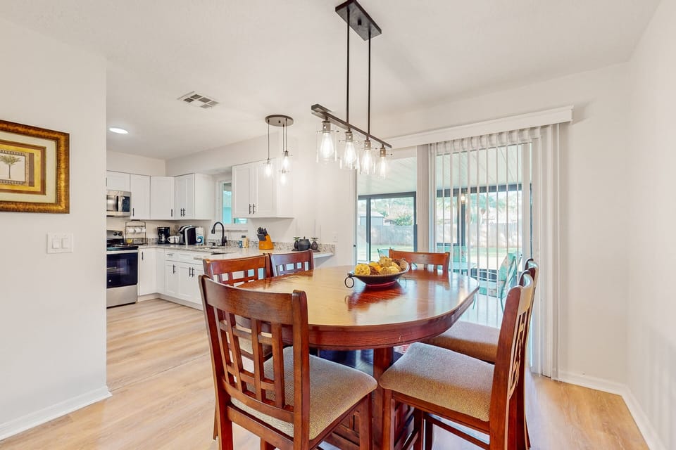 The dining area is nestled in the open plan between the kitchen and living room with seating for six.