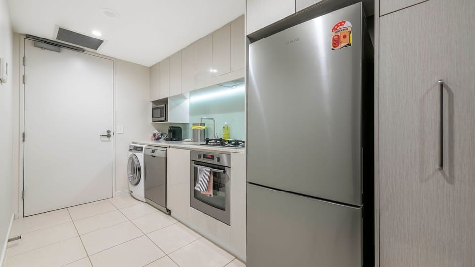 Internal laundry with washer, dryer, and full-size fridge