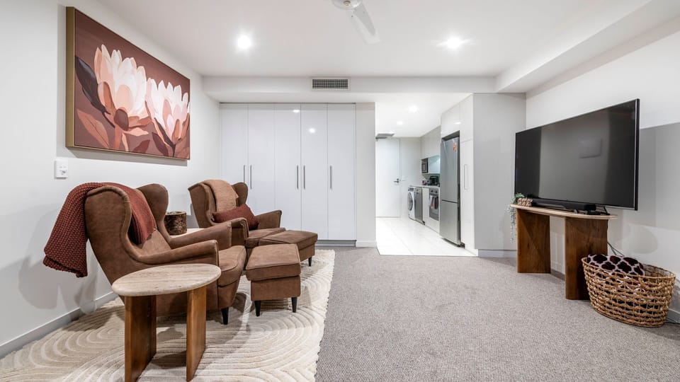 Spacious lounge with TV, soft furnishings, and relaxed layout