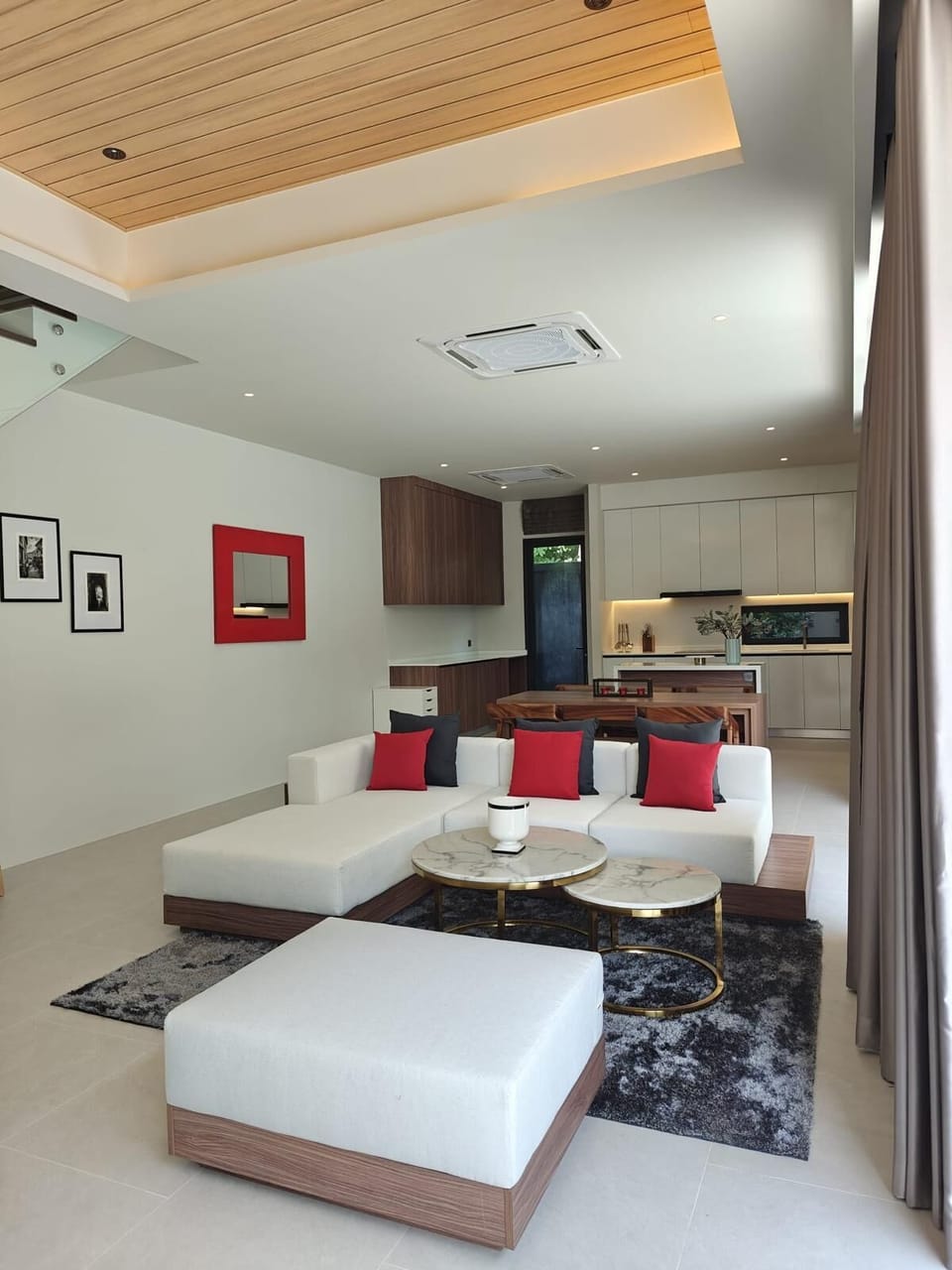 Bright open-plan living area connected to the modern kitchen, featuring comfortable seating and a stylish contemporary design