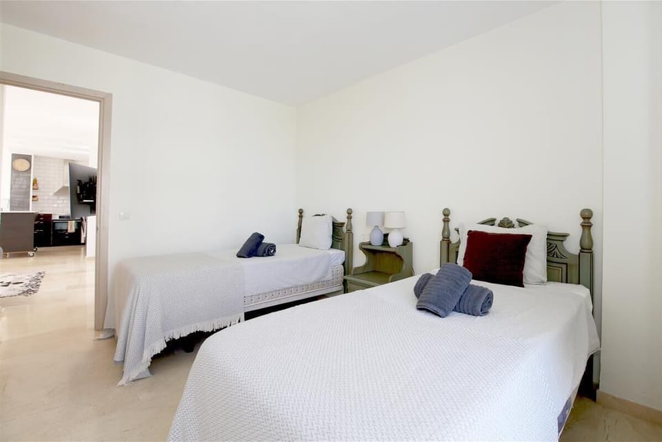 Another view of the twin bedroom with air conditioning