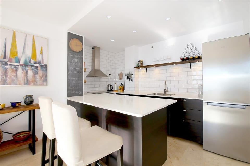 Another view of the open kitchen with dining area for two guests