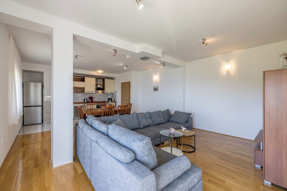 Spacious living room with sofa bed for two people and access to terrace.