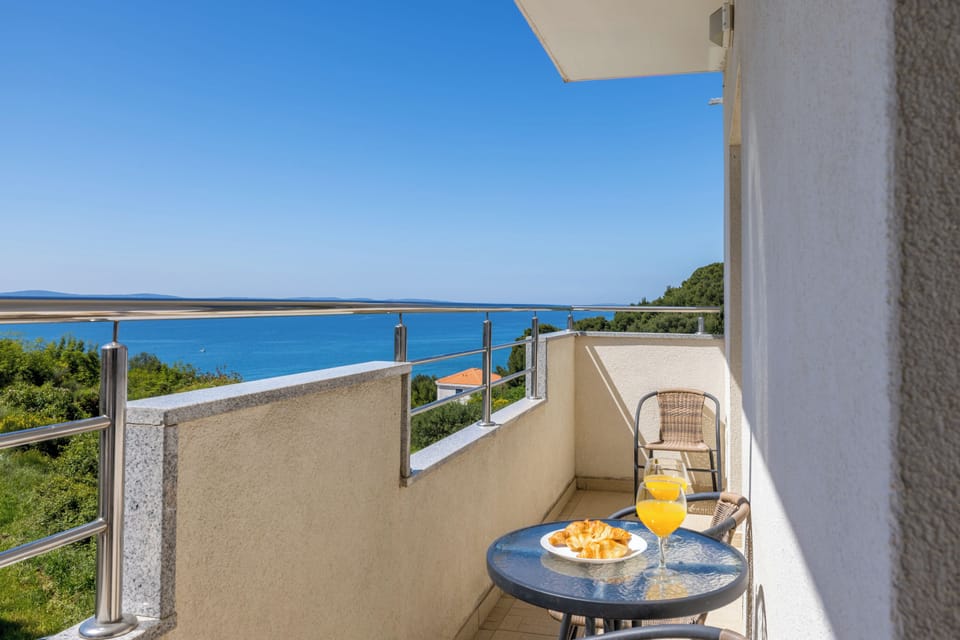 Balcony with sea view and seating area.