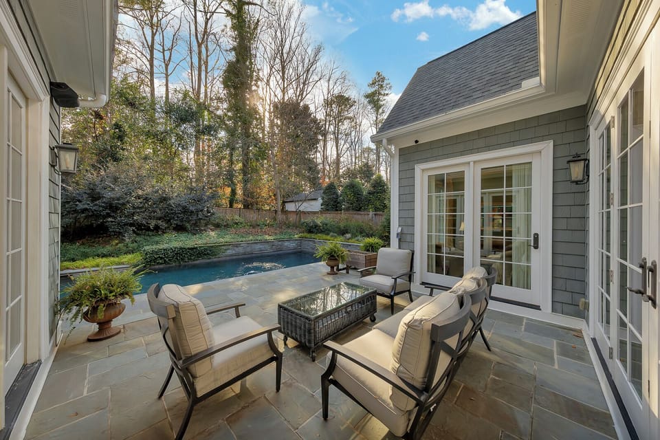 Poolside lounge w/ cushioned seating, a great spot to unwind by the water