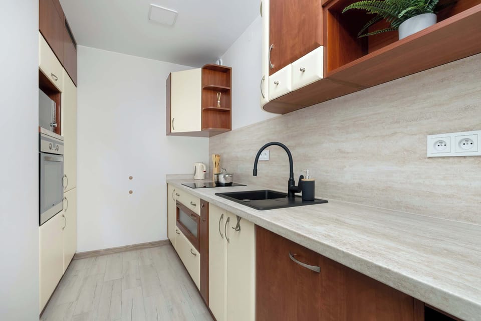 The sleek design of the kitchenette blending seamlessly with the living area.