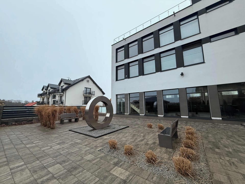 An outdoor area near the buildings with open space and surroundings suggesting a quiet neighborhood.