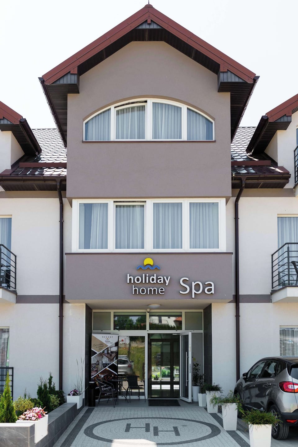A residential building exterior with a classic façade and multiple windows facing the street.