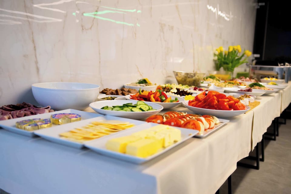 A cold buffet counter offering salads, vegetables, and fresh accompaniments.