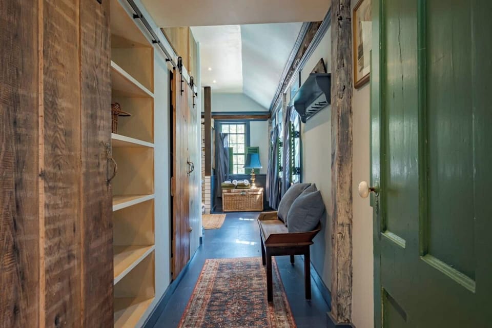 Doorway from the bedroom to the hallway leading to the attached private bathroom- plenty of closet space on the left